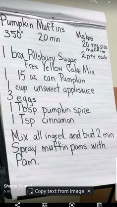 a white paper with writing on it next to a computer keyboard and monitor screen showing information about pumpkin muffins