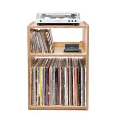 a wooden shelf with several different types of cds and cassettes on top of it