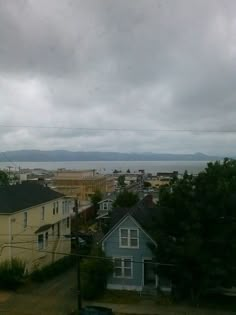 an overcast day with houses and water in the background