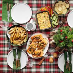 a table topped with plates and bowls filled with different types of food next to utensils