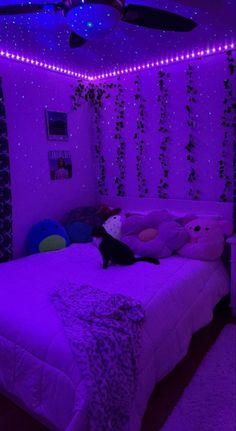 a bed room with a neatly made bed and purple lights on the wall above it