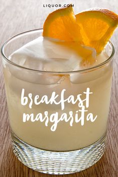 an orange slice sitting on top of a margarita in a glass with ice and the words breakfast margarita written below it