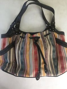 You are purchasing a brand new Caribbean Joe Purse tote bag. 2 side pockets on outside. Inside has one zippered pouch plus 2 pockets. Colorful stripes with palm trees. Brown faux leather handles. No tags but never used. There’s some small white spots on bottom please inspect photos carefully. Nice & clean inside. Bag Measures 15” x 10” x 4” PayPal only. Please remit payment within 3 days of purchase. Please feel free to make any inquiries prior to purchasing. My goal is to provide great service Casual Multicolor Canvas Satchel, Casual Multicolor Satchel For Shopping, Casual Multicolor Satchel For Errands, Vintage Multicolor Satchel For Everyday, Vintage Multicolor Everyday Satchel, Casual Multicolor Pouch Satchel, Vintage Multicolor Canvas Bag For Everyday Use, Retro Brown Cotton Bag, Casual Multicolor Hobo Bag With Leather Handles