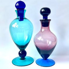 two colorful vases sitting next to each other