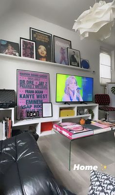 a living room filled with lots of furniture and pictures on the wall above it's tv