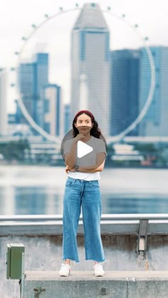 a woman standing in front of a city skyline