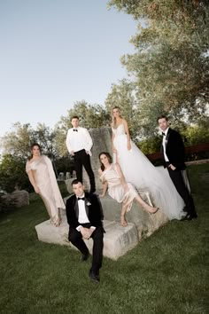 a group of people in formal wear posing for a photo