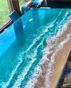 an ocean wave painted on the side of a window sill