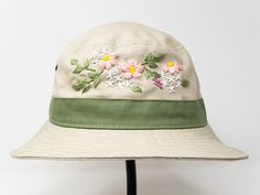 This hand embroidered cotton bucket hat is a stylish accessory that combines function with unique, handmade design. Made from high-quality cotton, it provides comfort and protection from the sun, making it perfect for outdoor activities. The intricate floral embroidery is meticulously crafted by hand, giving each hat a one-of-a-kind touch. Whether you're at the beach, camping, or just running errands, this cotton hat is both practical and fashionable. Item: flower embroidered bucket hat Material Beige Summer Hats With Embroidered Logo, Summer Wide Brim Hat With Embroidered Logo, Summer Hats With Embroidered Logo, Summer Embroidered Hat With Curved Brim, Adjustable Wide Brim Bucket Hat With Embroidered Logo, Embroidered Cotton Hat With Curved Brim, Summer Sun Hat With Embroidered Curved Brim, Spring Canvas Wide Brim Bucket Hat, Beige Canvas Hat With Short Brim