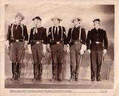 an old black and white photo of men in uniforms