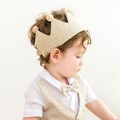 a little boy wearing a crown on top of his head