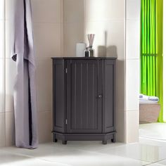 a bathroom with green curtains and a gray cabinet next to the bathtub is shown