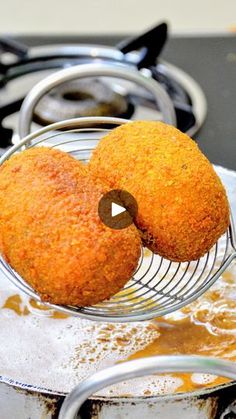 two fried food items on a wire rack over a stove top with oil in it