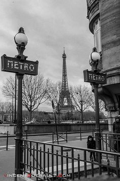 black and white photograph of the eiffel tower from across the street in paris