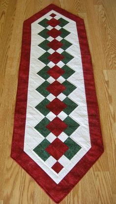 a red and green table runner on the floor