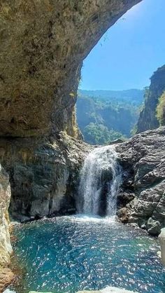 there is a large waterfall coming out of the cave