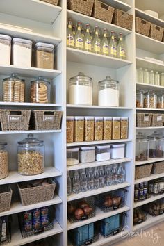 an organized pantry filled with lots of food and storage bins on shelving units