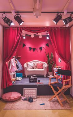 a living room with red curtains and furniture