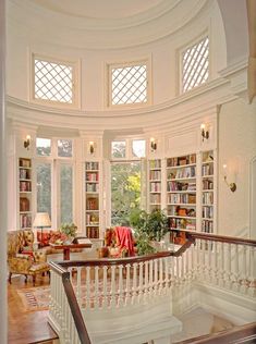 a living room filled with furniture and lots of windows