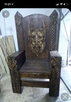 a wooden chair with an image of a horned animal on it's back and sides