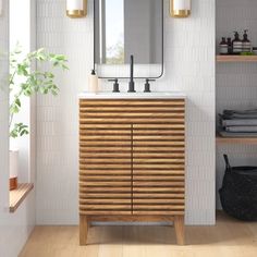 a bathroom with a wooden cabinet, mirror and shelves on the wall next to it