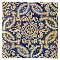 a blue and white tile with an intricate design