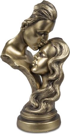 a bronze statue of two women kissing each other