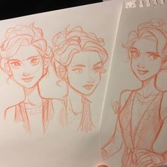 two drawings of princesses are shown in red ink on a notepad, one is drawn