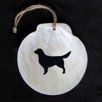 a white ornament with a black dog on it