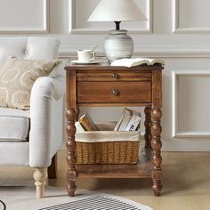 a wooden table with a basket on top of it next to a couch and lamp