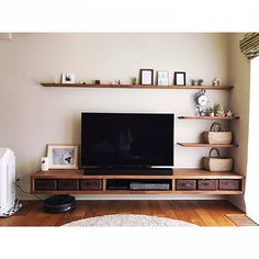 a flat screen tv sitting on top of a wooden entertainment center