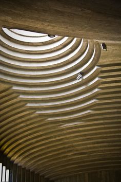 the inside of a building that is made out of wood and has wavy lines on it