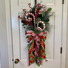 a door decorated with candy canes and greenery