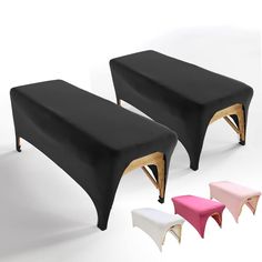 two black benches sitting next to each other on top of a white floor with wooden legs