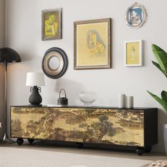 a living room scene with focus on the sideboard and wall art hanging above it