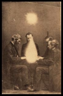 an old photo of three men sitting at a table with a penguin on it's head