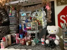 there is a hello kitty display on the shelf in this room with many items around it