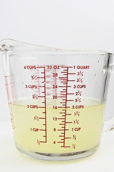 a measuring cup filled with liquid on top of a table