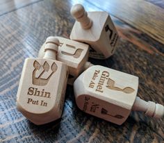 three wooden toy blocks sitting on top of a table with the words shin put in them