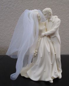 a wedding cake topper with a veil on it