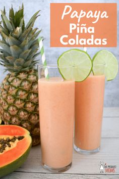 two glasses filled with pineapple and papaya drink next to a sliced watermelon