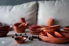 many bowls and plates are arranged on the couch