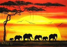 an elephant family is silhouetted against the setting sun