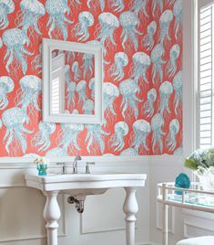 the bathroom is decorated in coral and blue