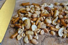 chopped nuts on a cutting board next to a knife