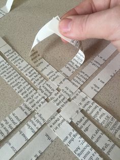 someone is cutting up strips of paper with scissors