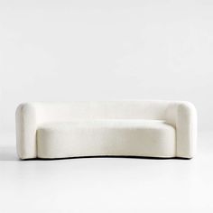 a white couch sitting on top of a white floor