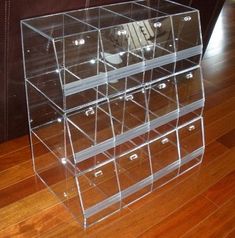 an acrylic display case on a wooden floor