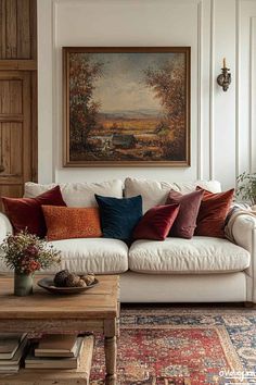 a living room filled with furniture and a painting on the wall