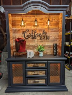 a display case with wooden walls and lights above it that says coffee bar on the side